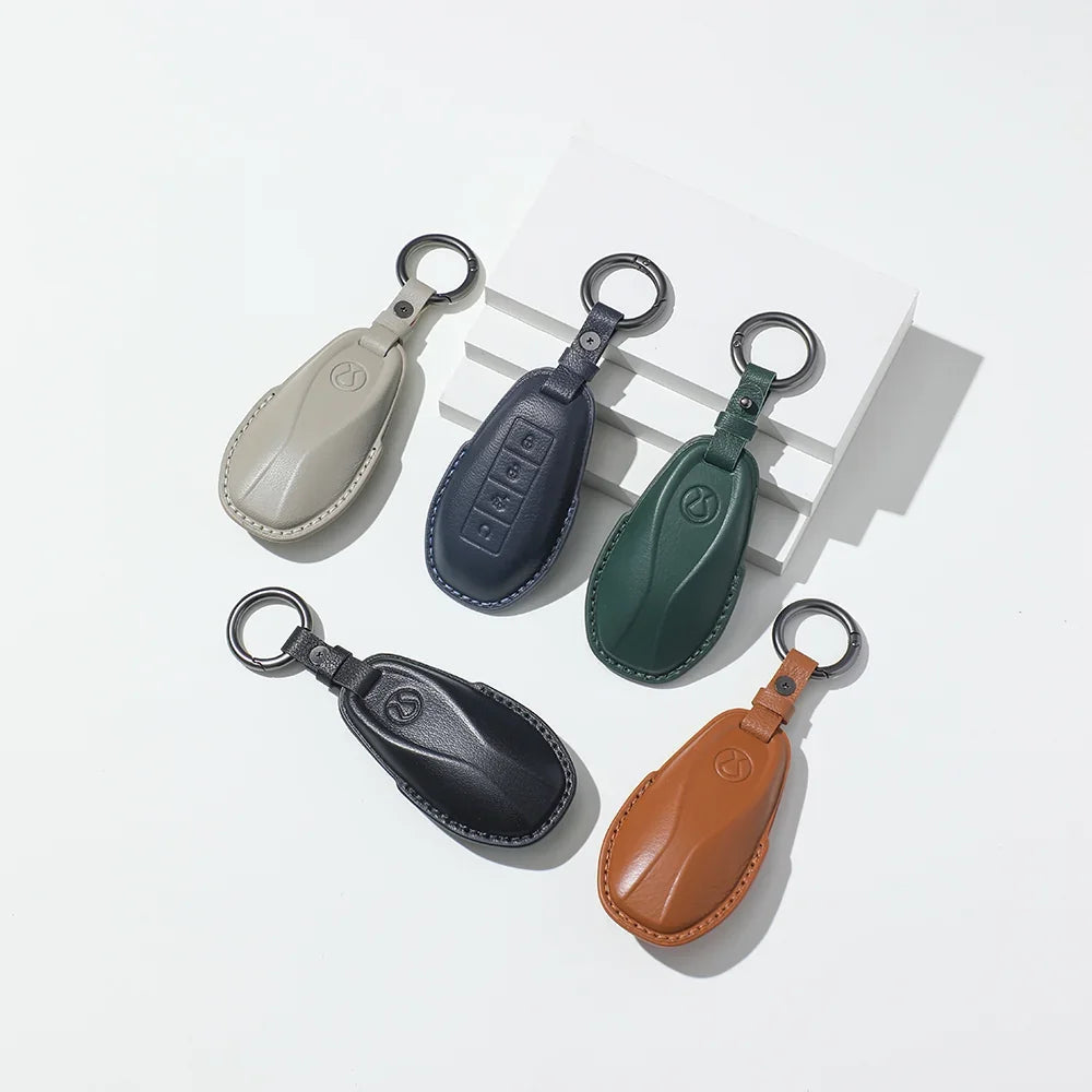 Set of five premium leather car key fob covers in beige, navy, green, black, and tan colors.