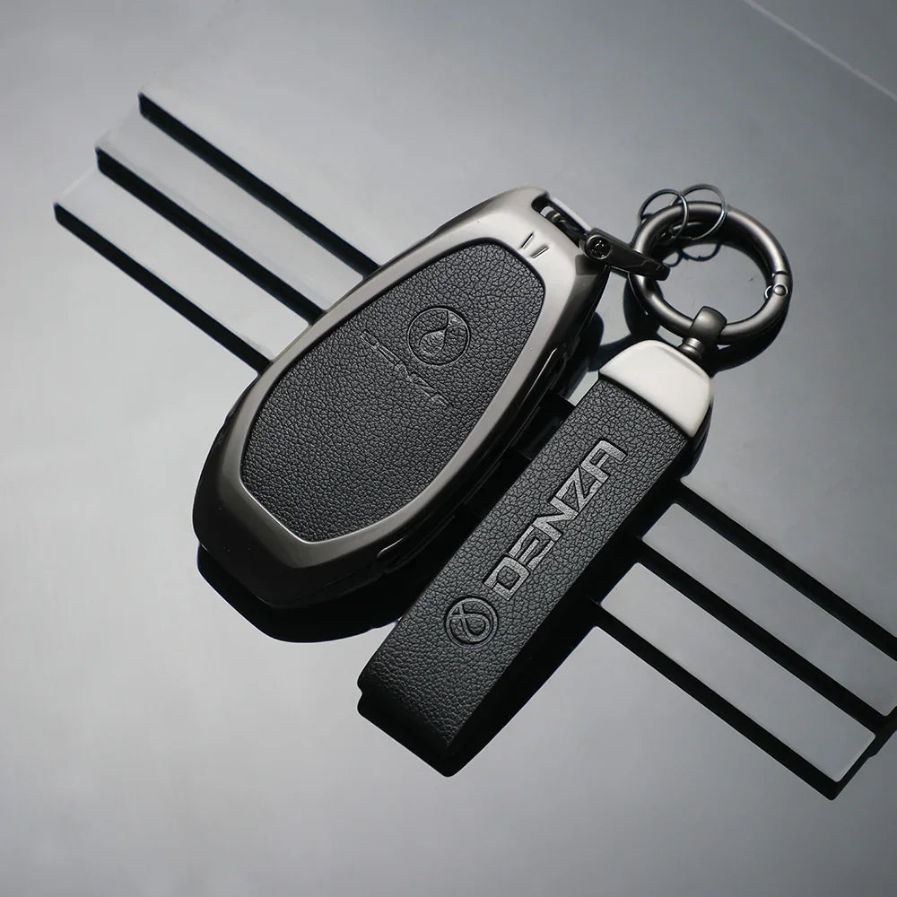Black leather key cover and fob strap for DENZA car key with textured finish.