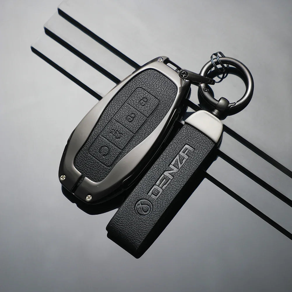 Black leather Denza car key case with matching branded strap and silver hardware.
