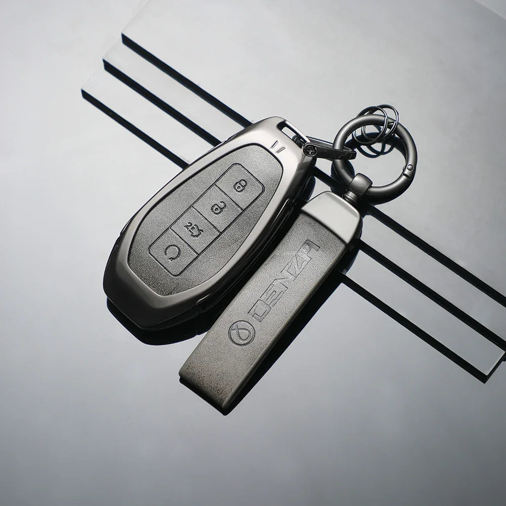 Professional matte grey metallic car key cover and matching keychain for BYD vehicle.