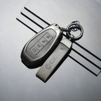 Professional matte grey metallic car key cover and matching keychain for BYD vehicle.