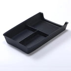 Black plastic car console organizer tray with two compartments for automotive storage.