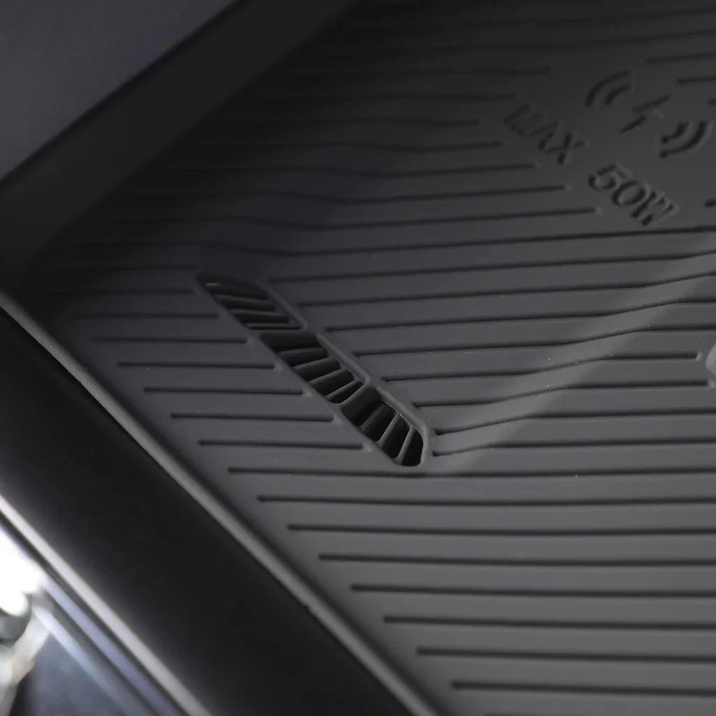 Black heavy-duty rubber car floor mat with textured non-slip surface and drainage slots.