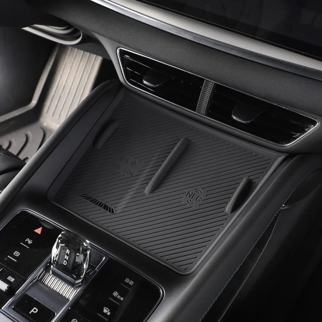 Black silicone wireless charging mat installed on a BYD car center console for efficient charging.