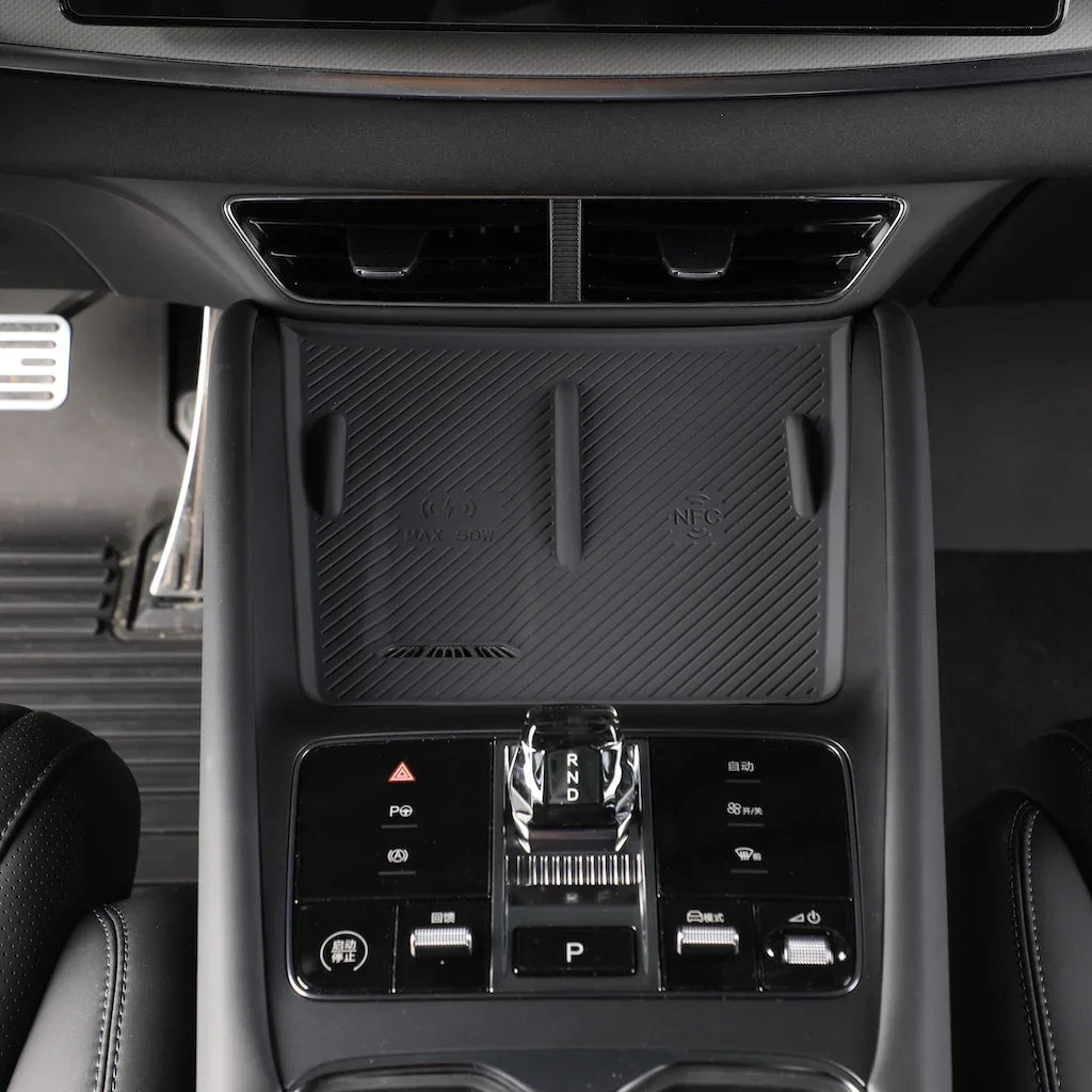 Black textured non-slip wireless charging pad and NFC console tray for BYD interior.