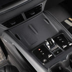 Black textured wireless charging pad and center console control panel for BYD vehicle interior.