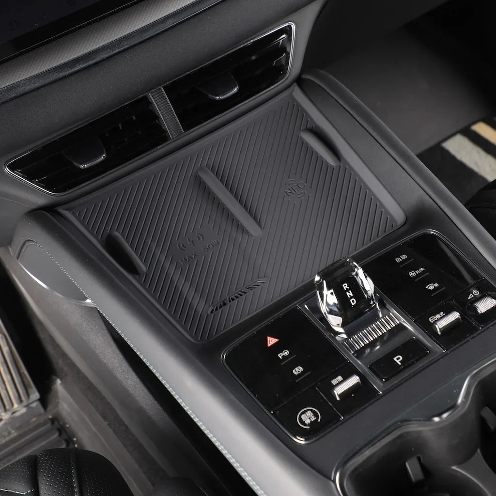 Black textured wireless charging pad and center console control panel for BYD vehicle interior.