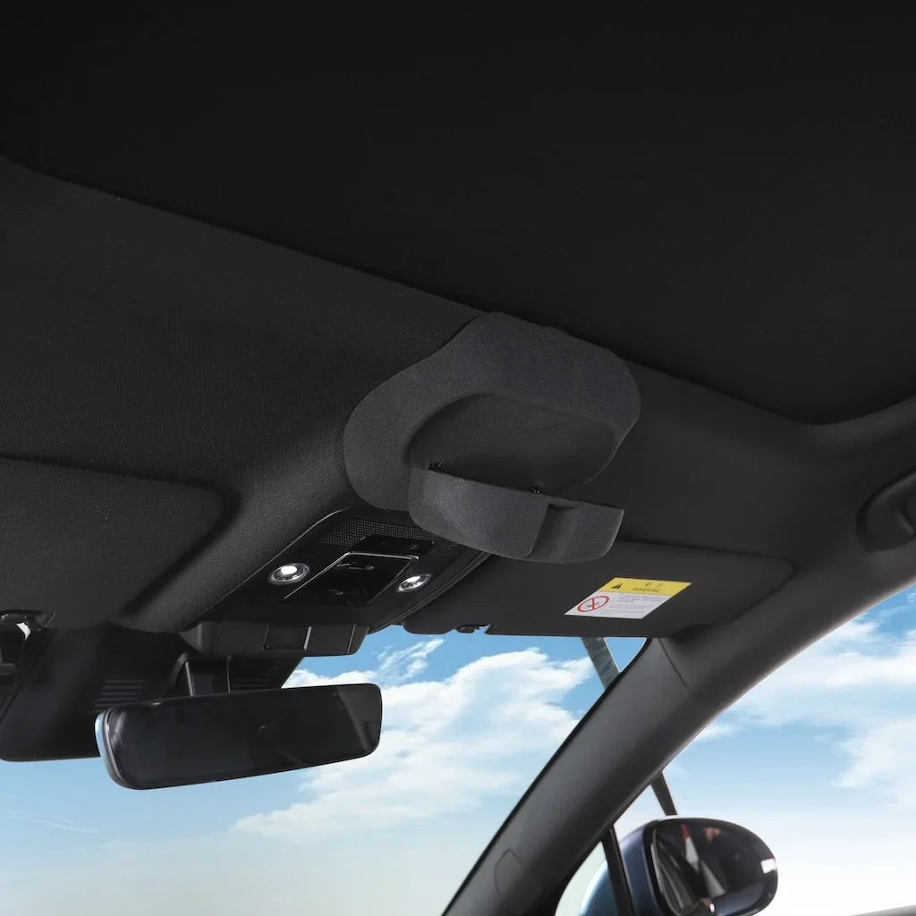 Black fabric car sun visor with integrated storage compartment for organized interior storage.