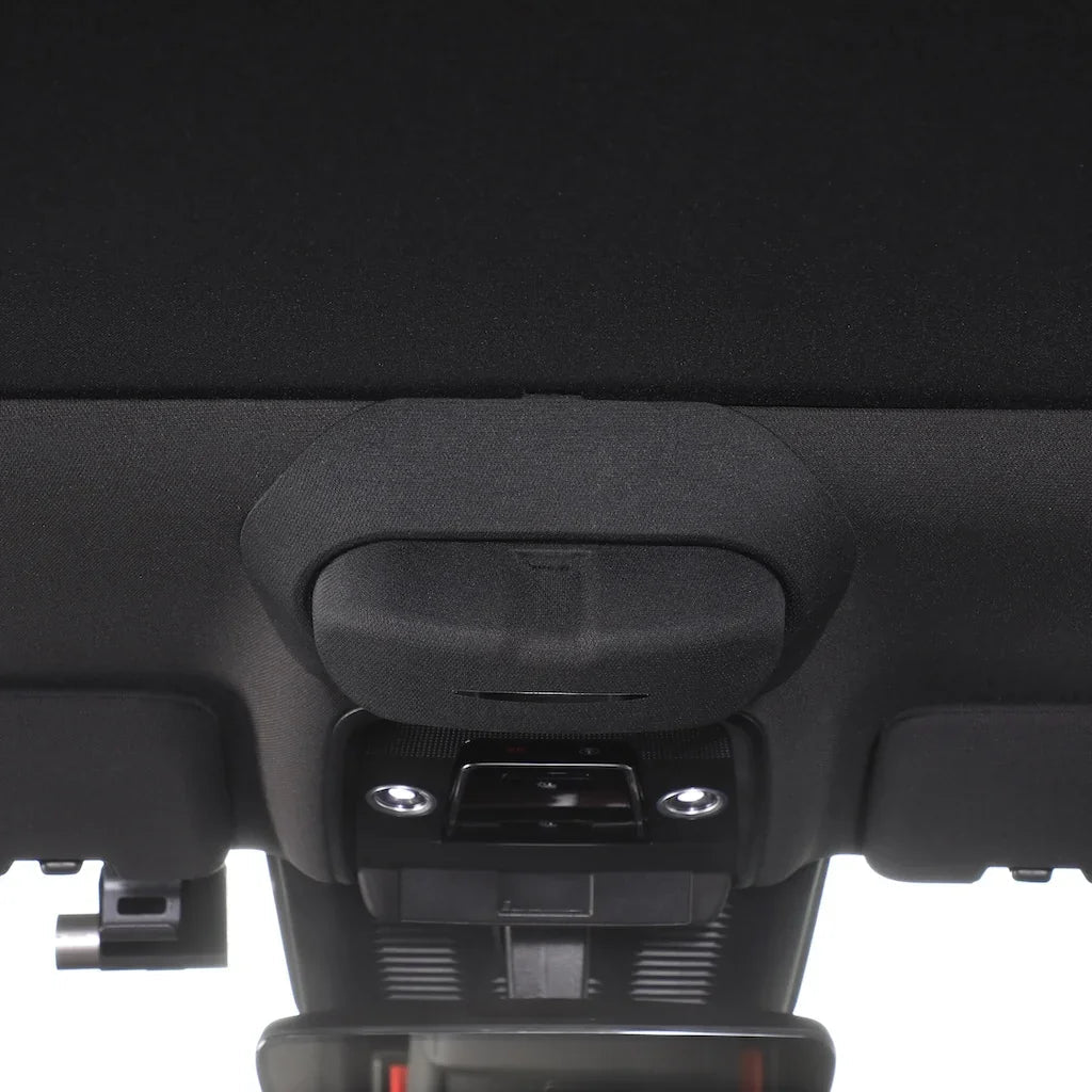 Black fabric-covered interior trim component with a durable matte finish.