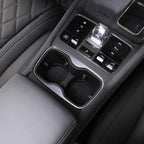 Black leather interior featuring dual cup holders and a sleek chrome gear shifter console.