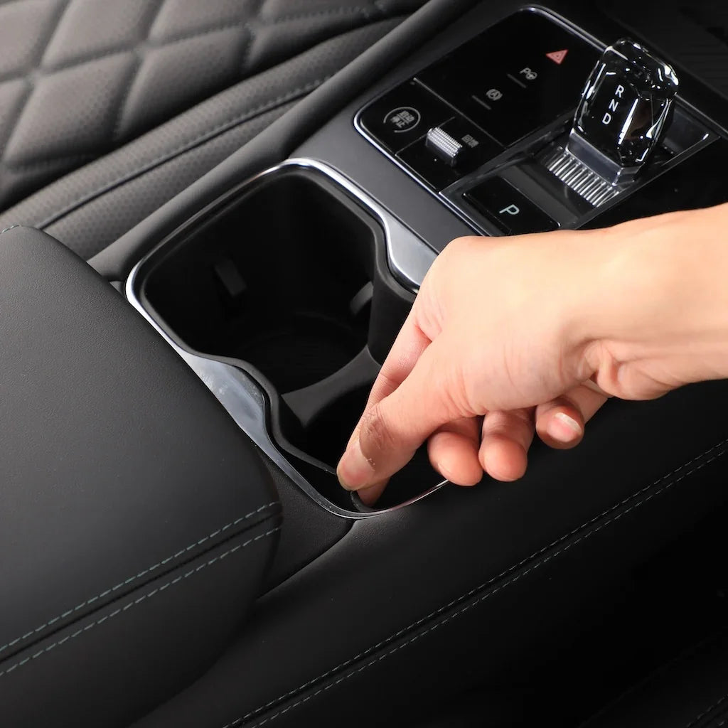 Black leather interior featuring a sleek chrome-trimmed cup holder accessory for BYD vehicles.