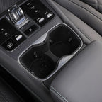 Black leather interior featuring a sleek chrome-trimmed dual cup holder for BYD accessories.