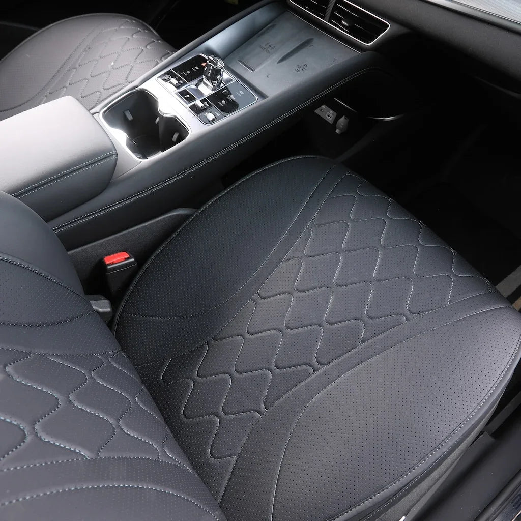 Black leather car seat covers with a unique diamond quilted pattern and perforated center.