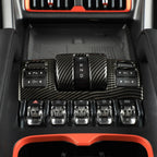 Carbon fiber texture gear shifter panel with black and red interior accents.