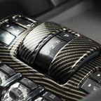 Glossy black carbon fiber gear shifter console with P R N D transmission controls.