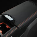 Black leather center console armrest cover with contrast orange stitching for BYD accessories.