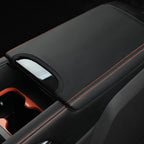 Black leather center console armrest cover with contrast orange stitching for BYD accessories.