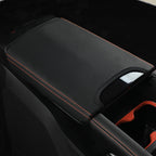 Black leather center console armrest cover with premium red contrast stitching.