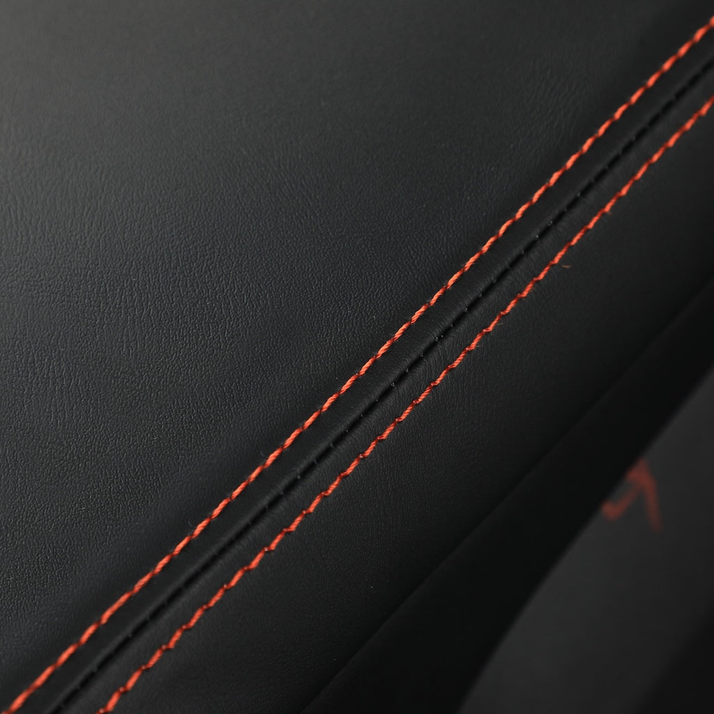 Black premium leather car seat upholstery with contrasting red decorative stitching.