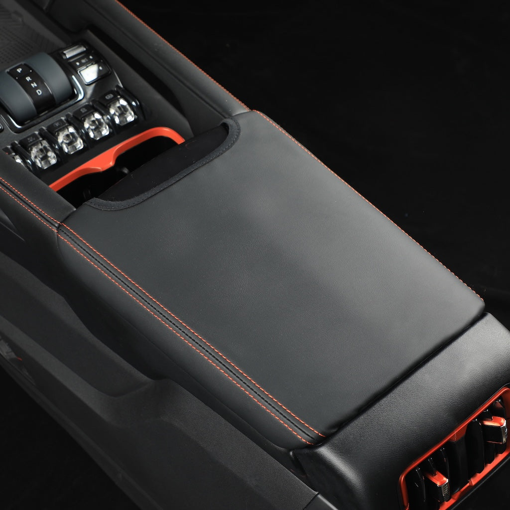 Black leather center console cover with orange contrast stitching for BYD vehicle protection