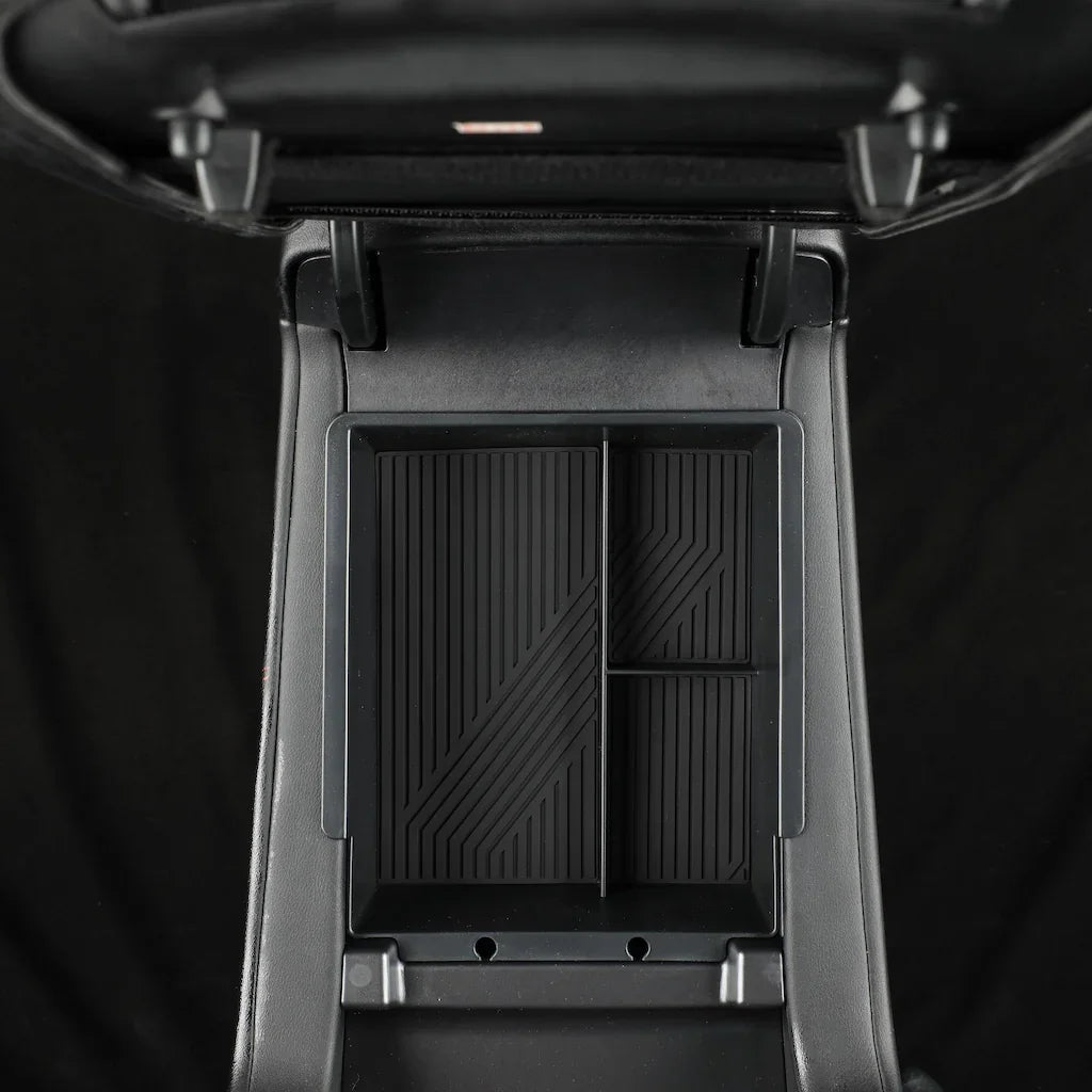 Black durable plastic center console organizer tray with ribbed anti-slip texture.