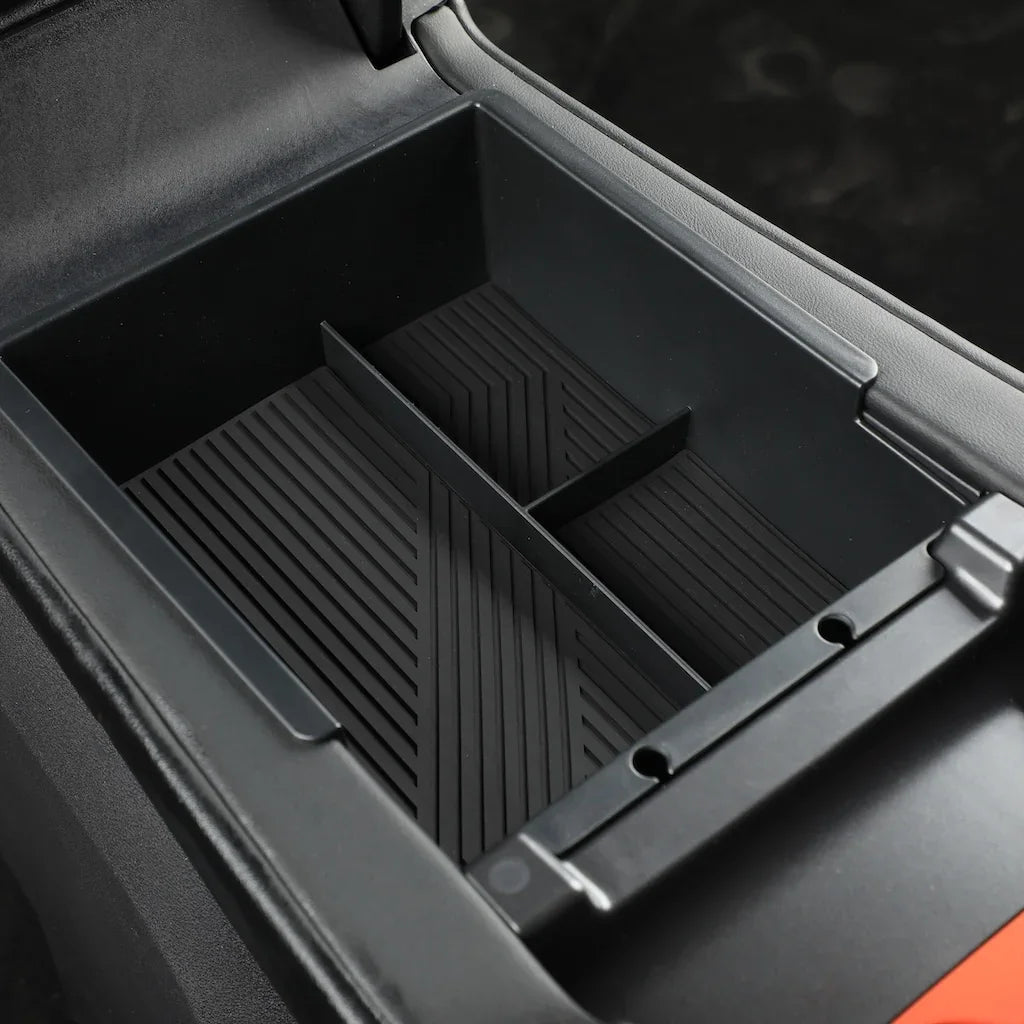 Matte black center console organizer tray with ribbed anti-slip texture for car interior