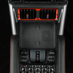 BYD car center console accessory with red accents and black textured NFC charging pad.