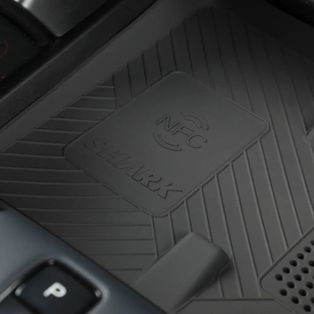 Close-up of a professional black rubber car mat featuring an NFC sensor and SHARK branding.