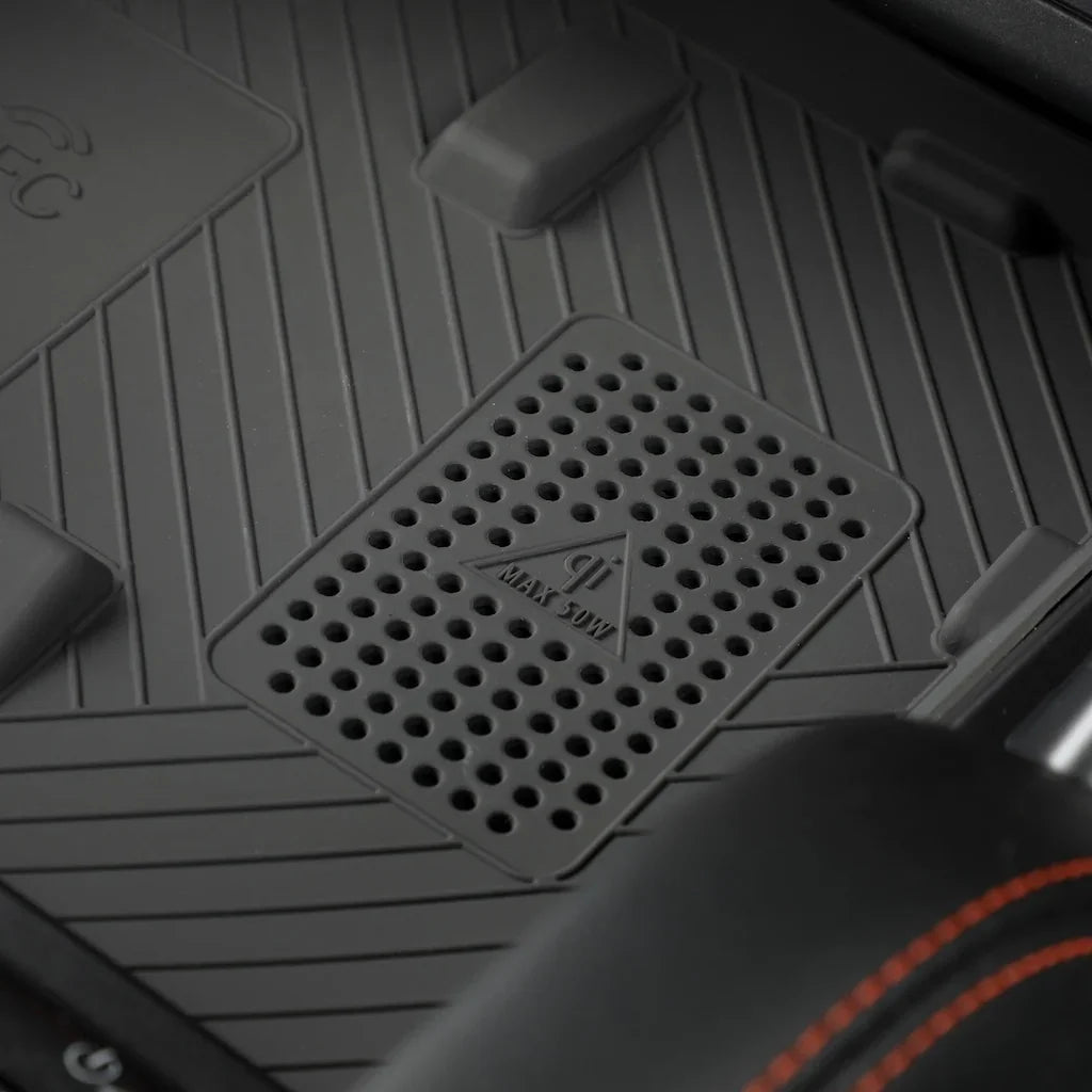Close-up of a black textured car mat featuring a built-in wireless charging pad.
