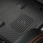 Close-up of a black textured car mat featuring a built-in wireless charging pad.