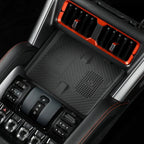 Matte black textured center console protector for BYD with orange trim accents.