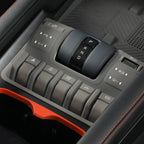 Close-up of a gray and orange BYD car console with a gear shifter and various control buttons.