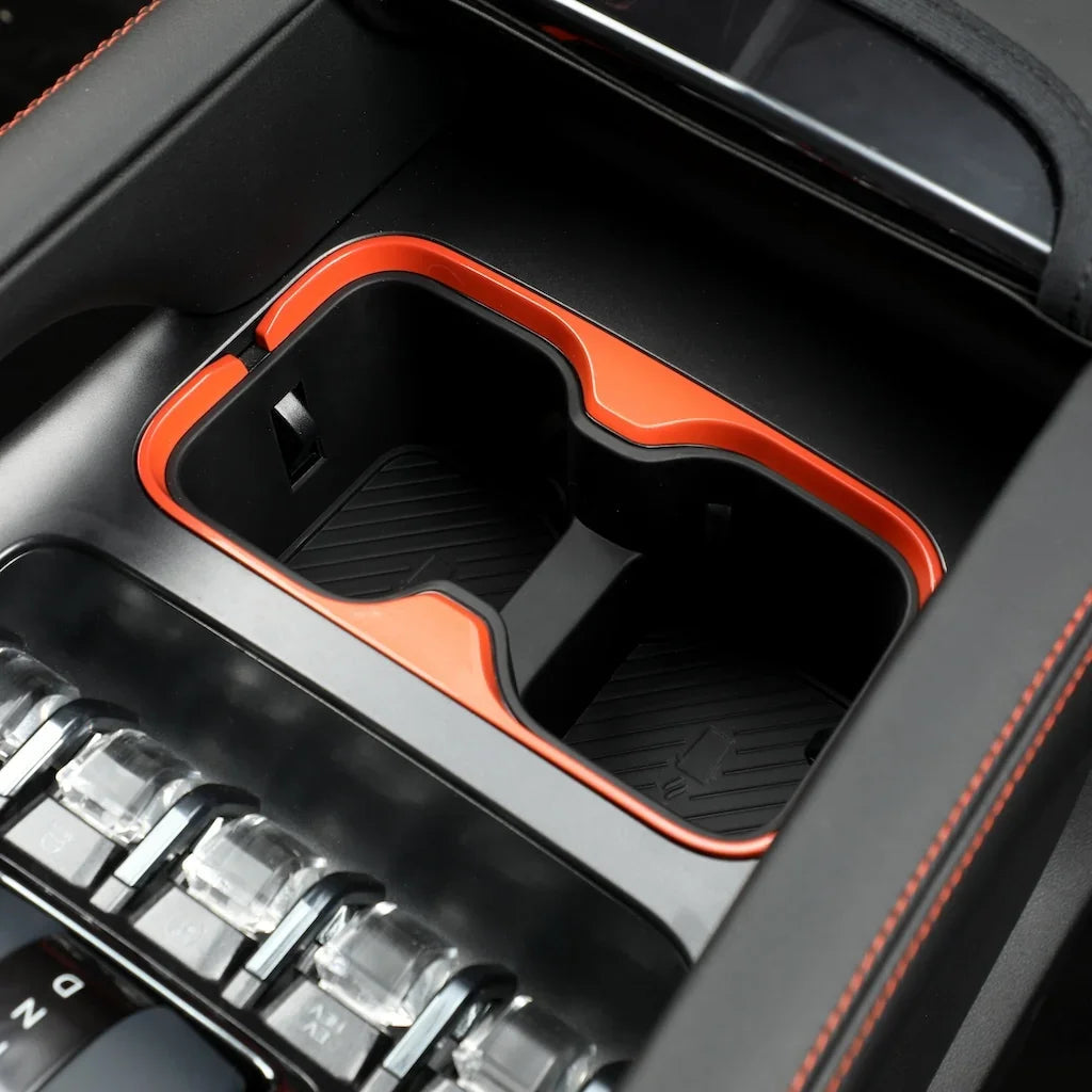 Black dual car cup holder with vibrant orange trim for BYD interior customization.