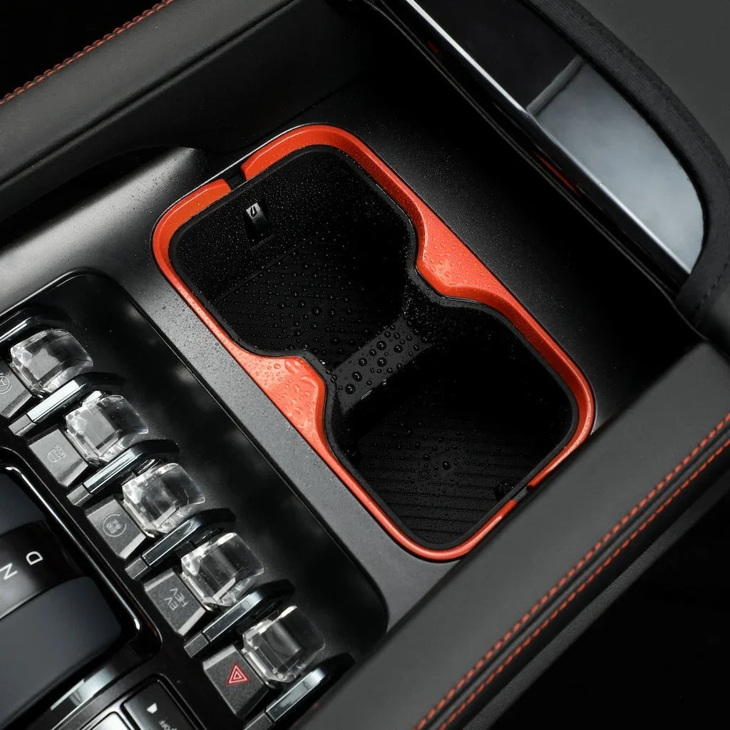 Black waterproof car cup holder tray with vibrant orange trim for BYD interior protection.