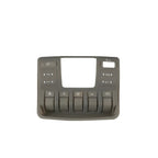 Grey matte plastic interior control panel with various vehicle function buttons.