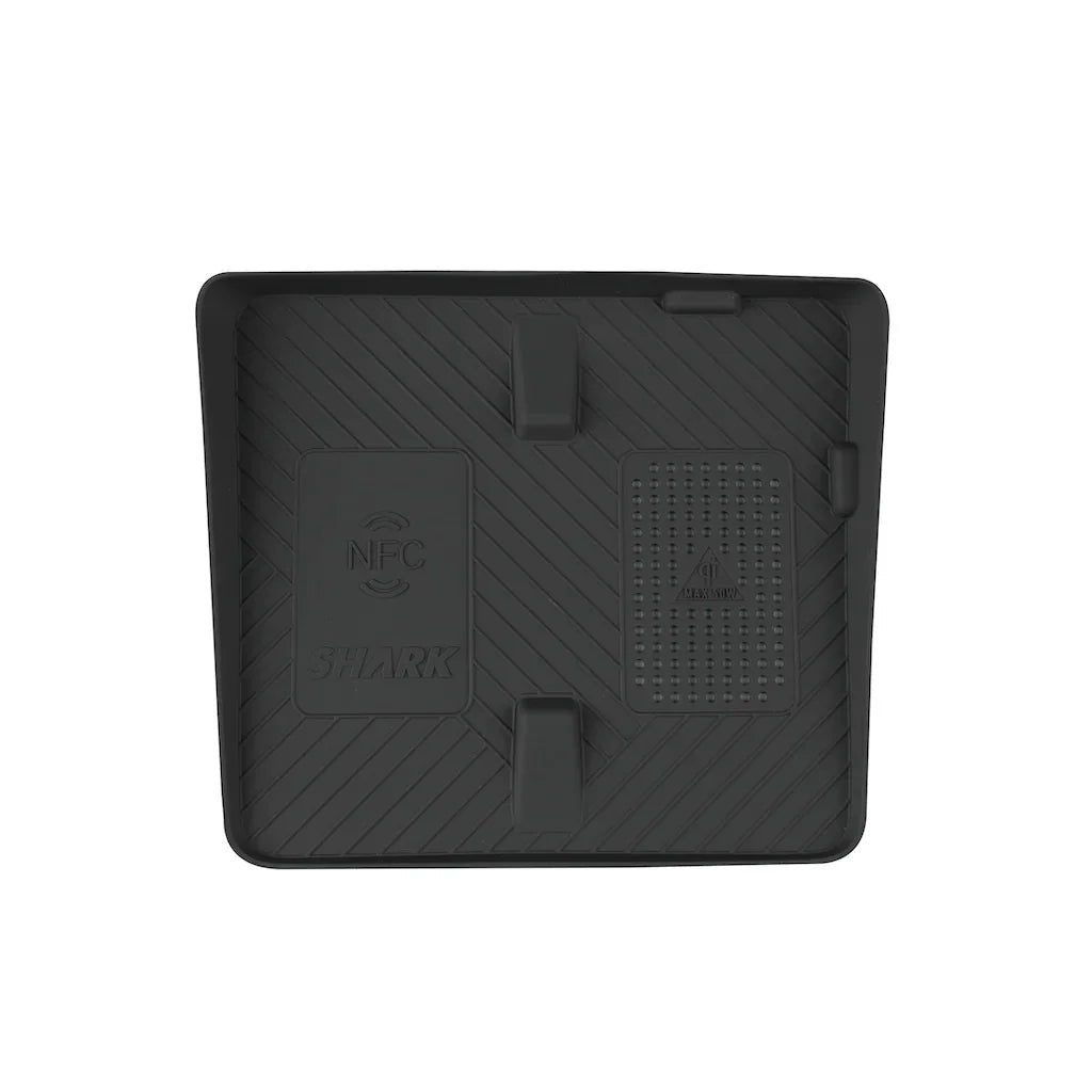 Black textured rubber car center console tray with NFC charging area and Shark branding.
