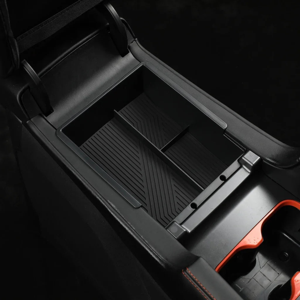 Close-up of a professional black plastic car center console organizer with a textured interior.