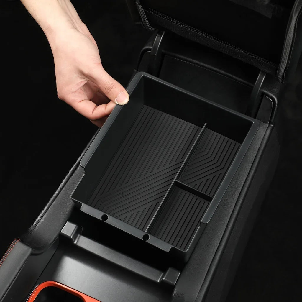 Black matte plastic center console organizer tray with ribbed non-slip surface