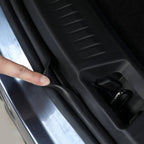 Black flexible rubber weatherstripping seal being installed on a silver car door frame.