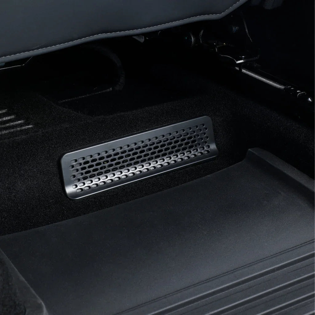 Black perforated metal floor vent cover for vehicle interior protection.
