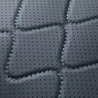 Premium black perforated leather texture with decorative diamond stitching for car interiors.