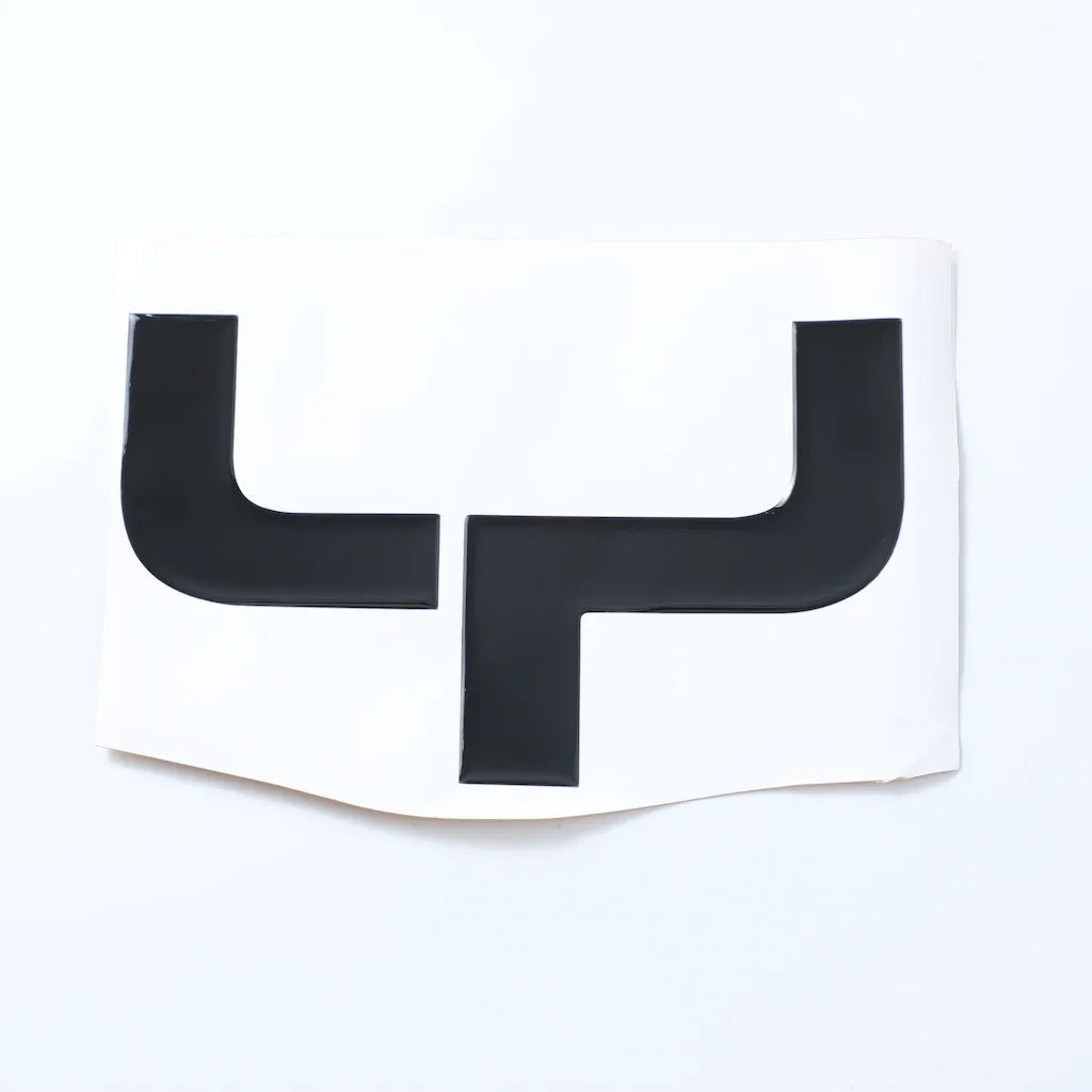 Black high-gloss protective trim piece made of durable material on a white background.