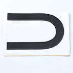 Black glossy U-shaped trim protector made of durable material for car body protection.