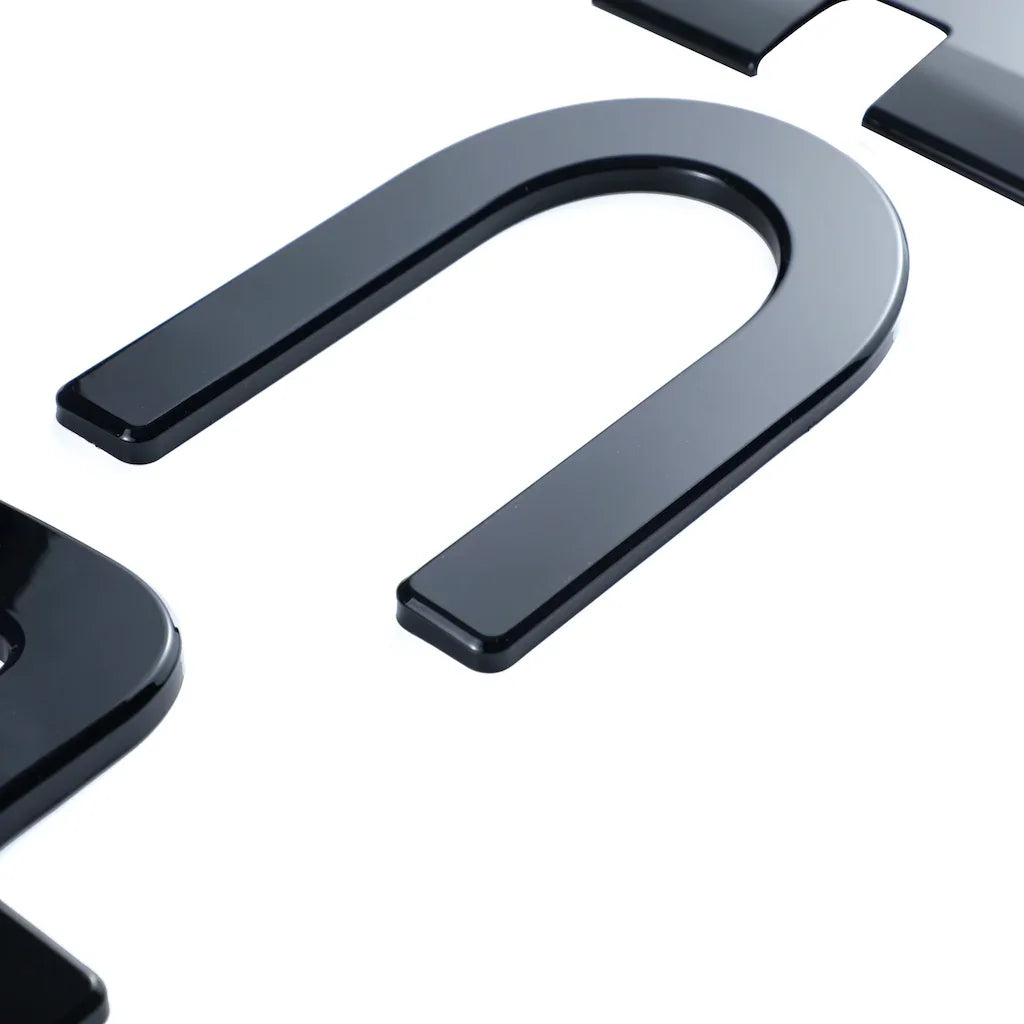 Glossy black high-quality emblem piece for BYD car accessories.