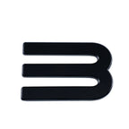 Glossy black E-shaped decorative emblem with a sleek, high-shine finish.