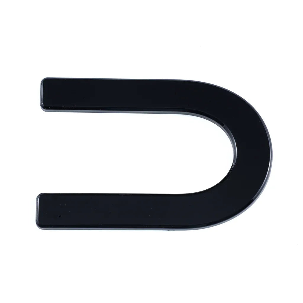 Glossy black U-shaped automotive trim accessory made of durable high-shine material.