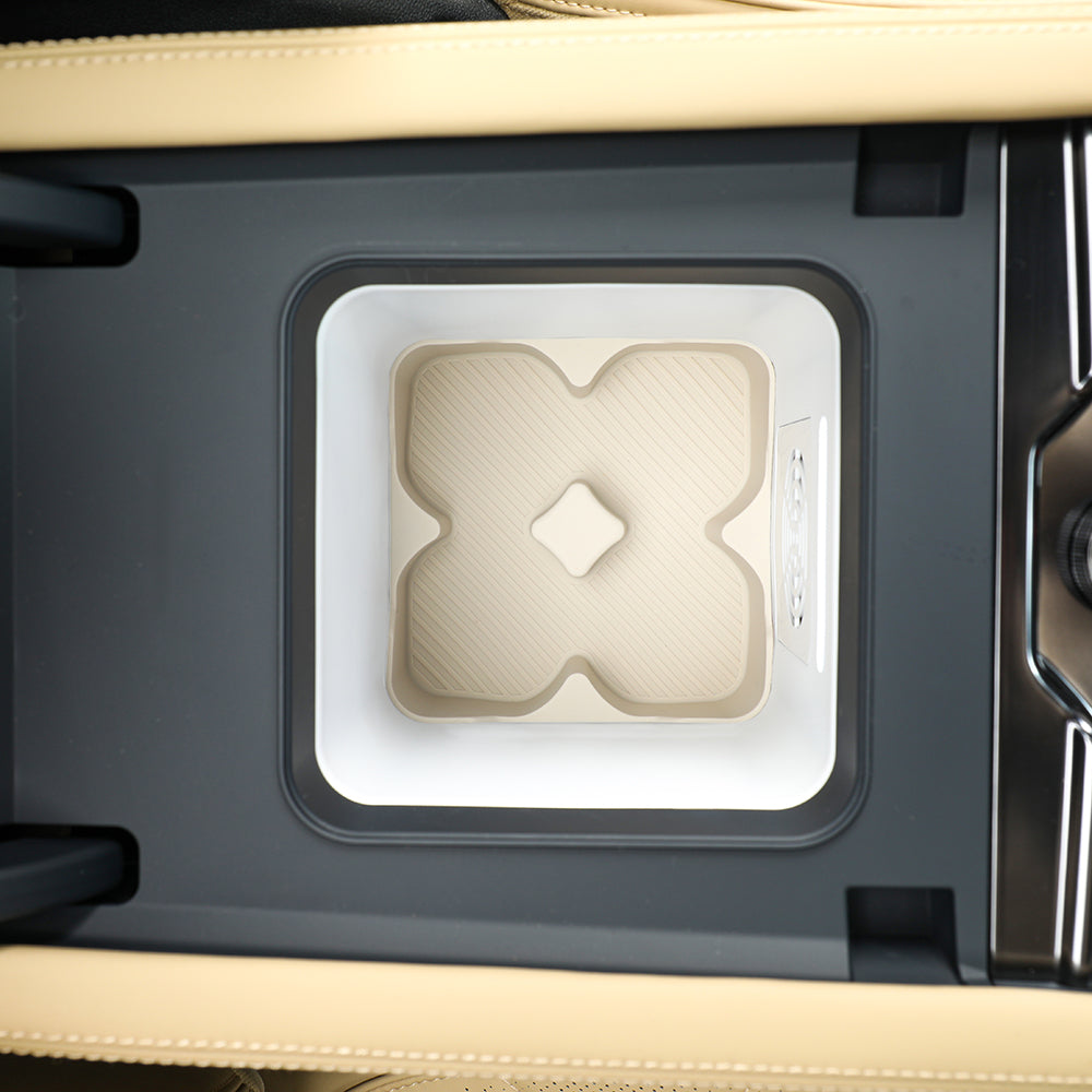 Beige textured center console organizer tray with a white frame for car interior.