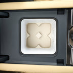 Beige textured center console organizer tray with a white frame for car interior.