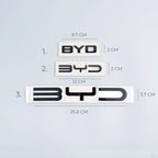 Three sizes of black chrome BYD emblems with precise metric dimensions on white background.