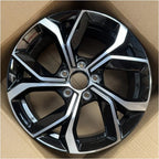 Two-tone black and silver metallic alloy car wheel rim with a sleek geometric spoke design.